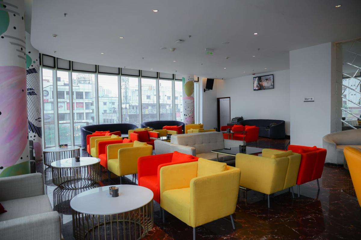 a room filled with colorful chairs and tables at Le Meridien Hyderabad in Hyderabad