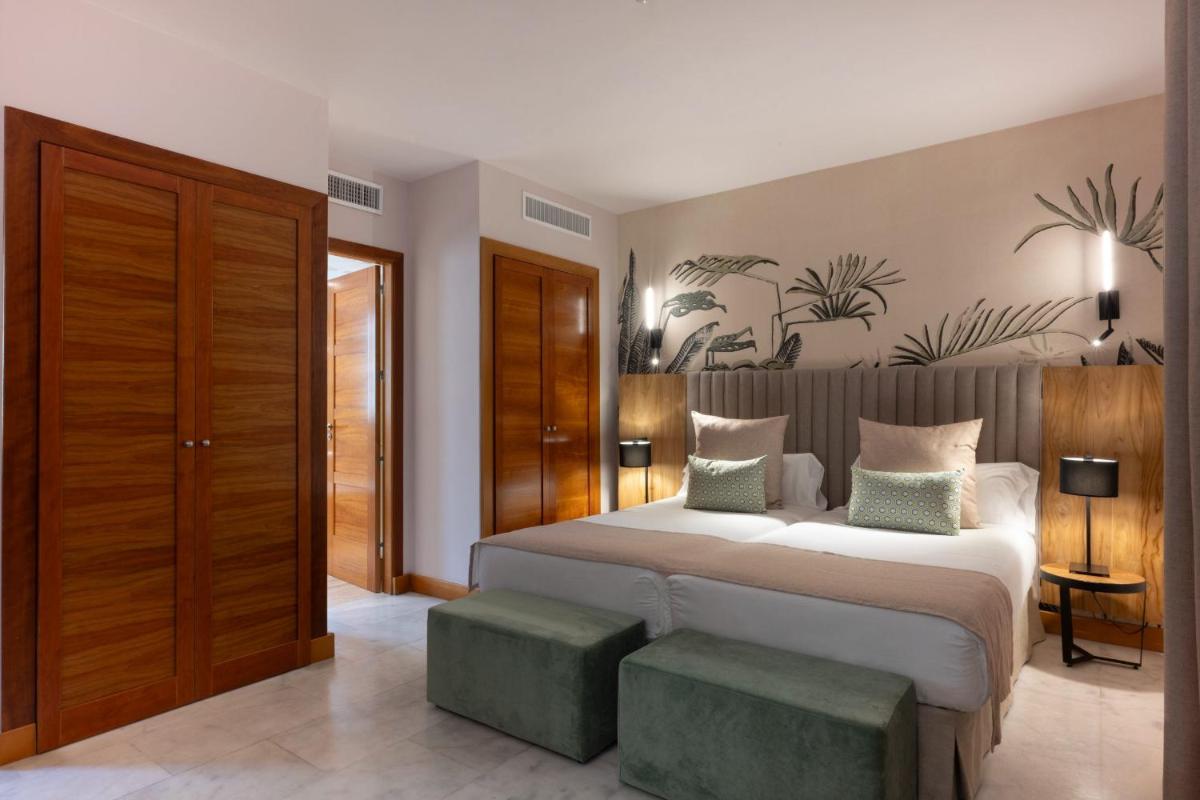Cama o camas de una habitación en Hotel Suite Villa Maria
