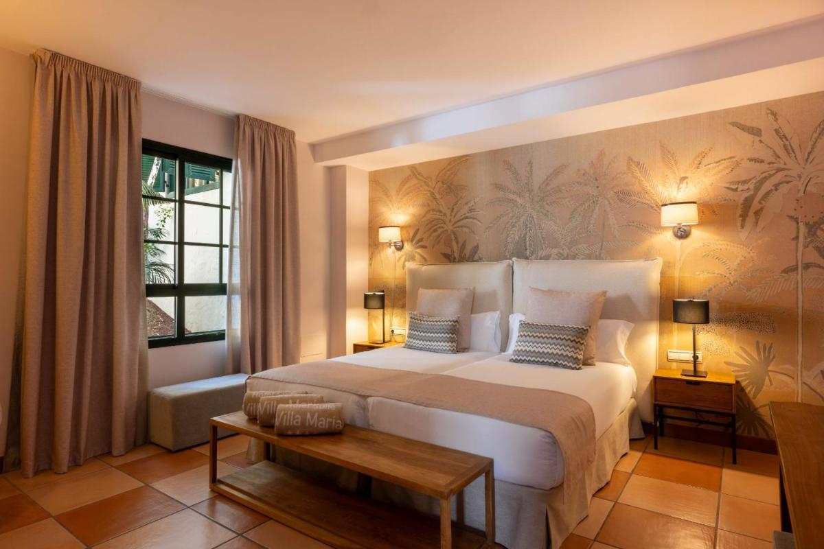 Cama o camas de una habitación en Hotel Suite Villa Maria