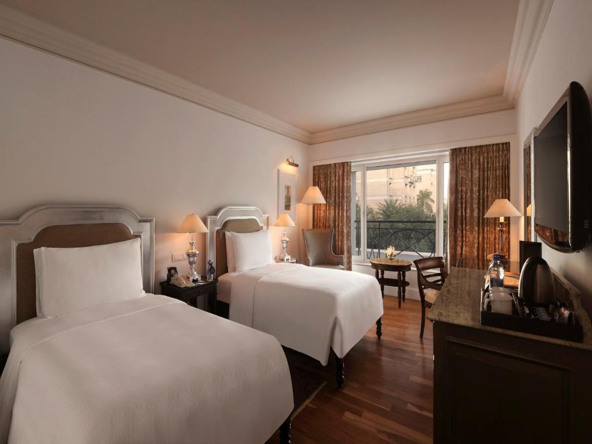 a hotel room with two beds and a television at Hilton Mumbai International Airport Hotel in Mumbai