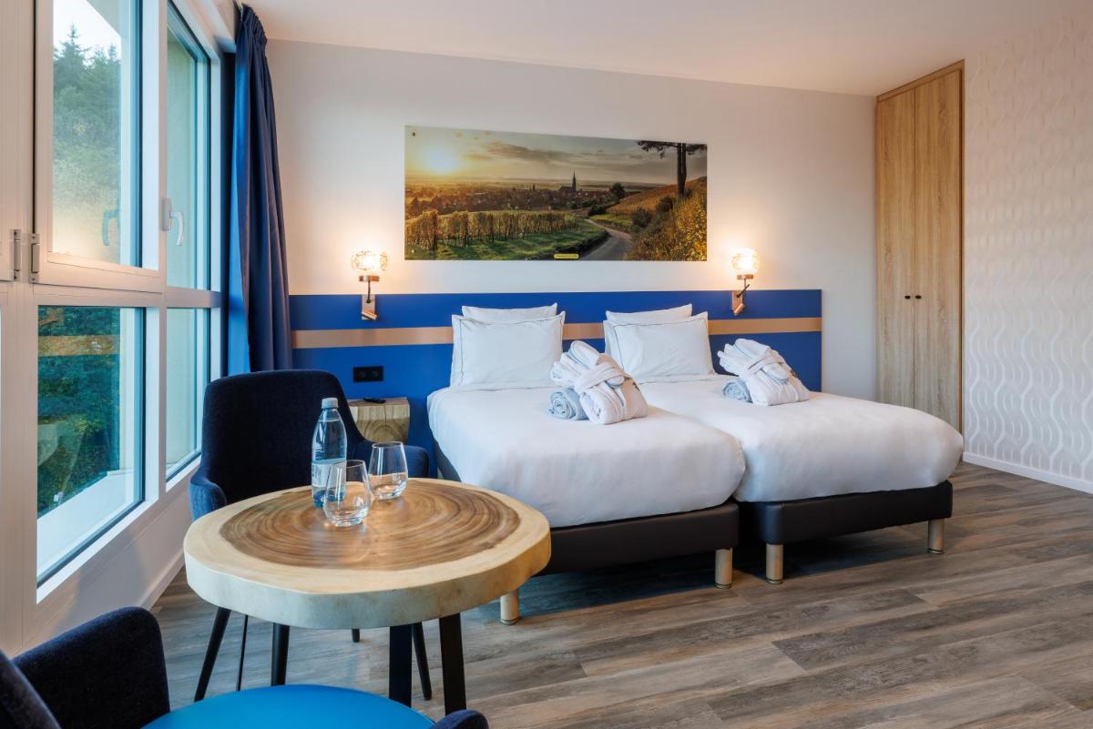 Un ou plusieurs lits dans un hébergement de l'établissement Hotel SPA Husseren Collections - Proche Colmar - Eguisheim