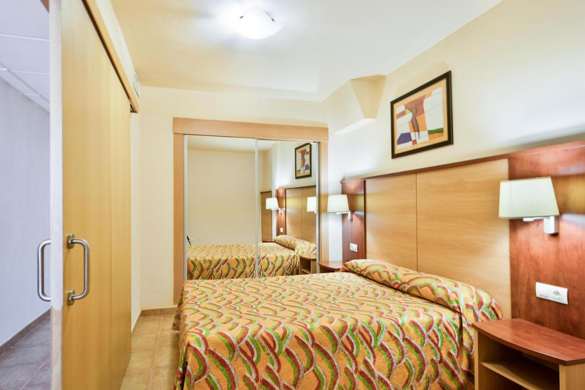 Cama o camas de una habitación en Apartamentos Best Alcazar