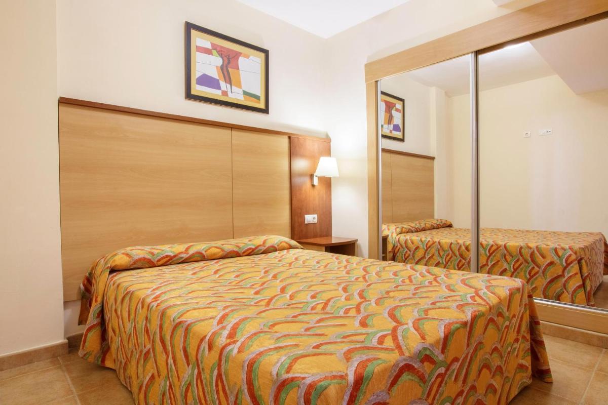 Cama o camas de una habitación en Apartamentos Best Alcazar