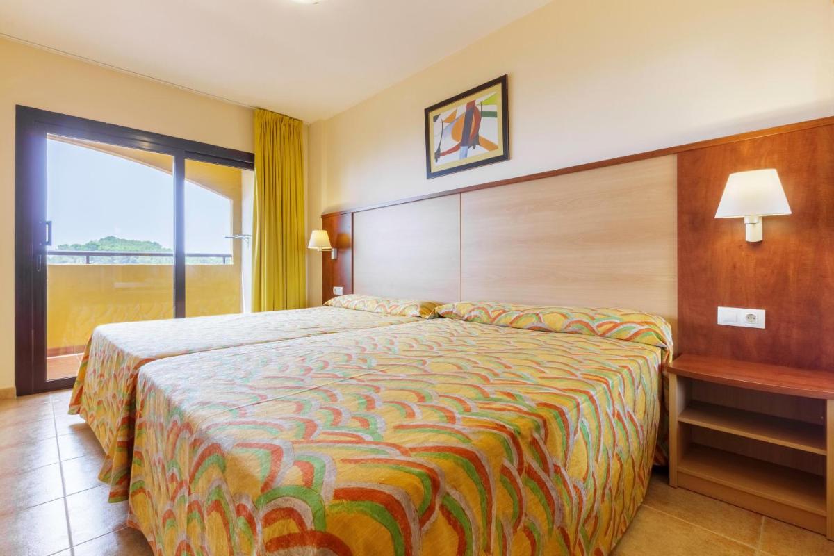 Cama o camas de una habitación en Apartamentos Best Alcazar