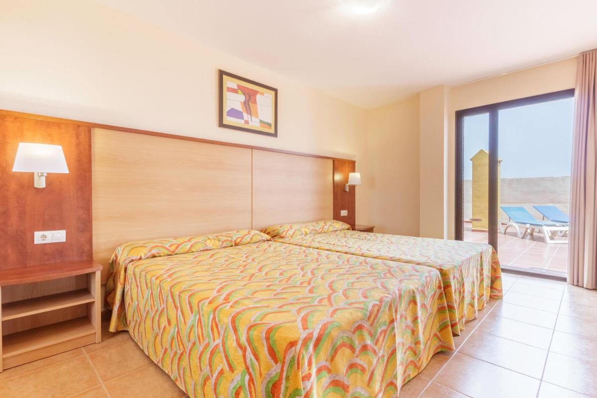 Cama o camas de una habitación en Apartamentos Best Alcazar