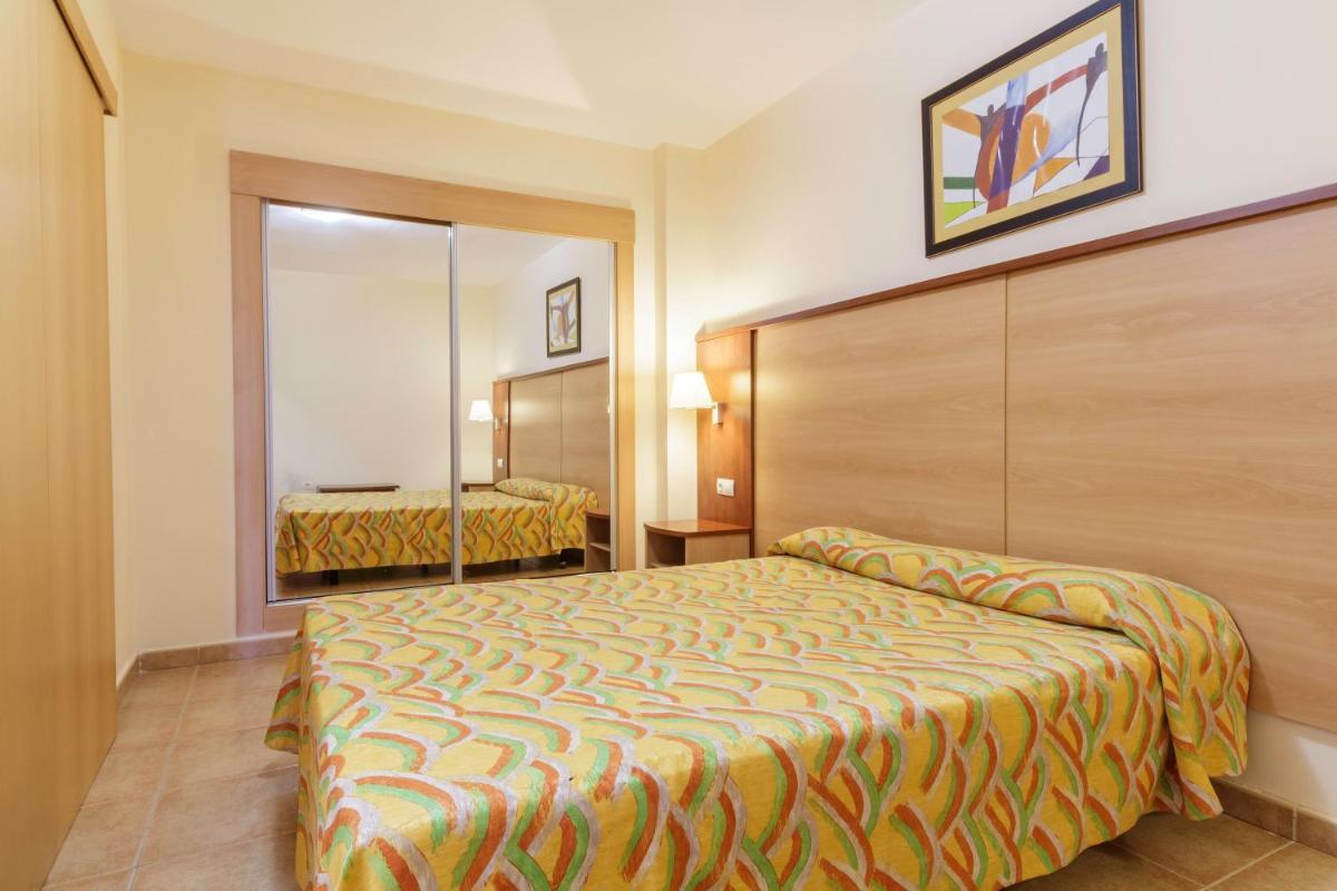 Cama o camas de una habitación en Apartamentos Best Alcazar