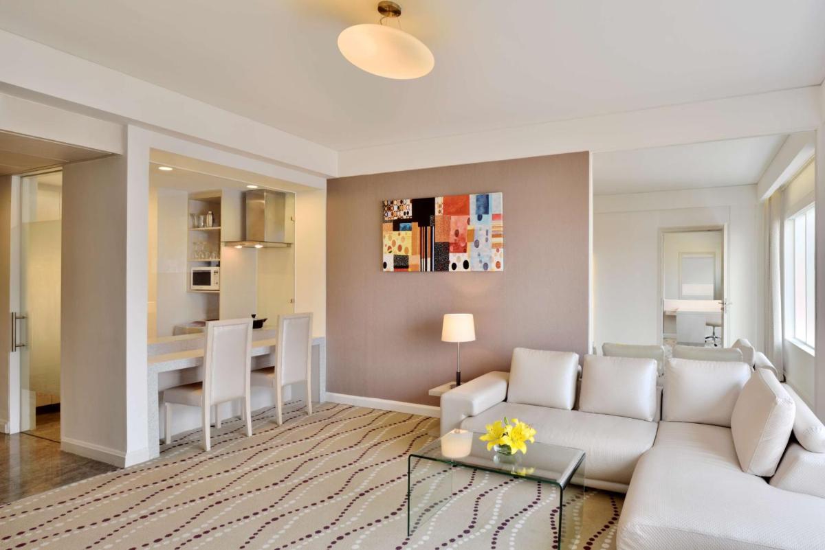 a living room with a couch and a table at Radisson Blu Bengaluru Outer Ring Road in Bengaluru