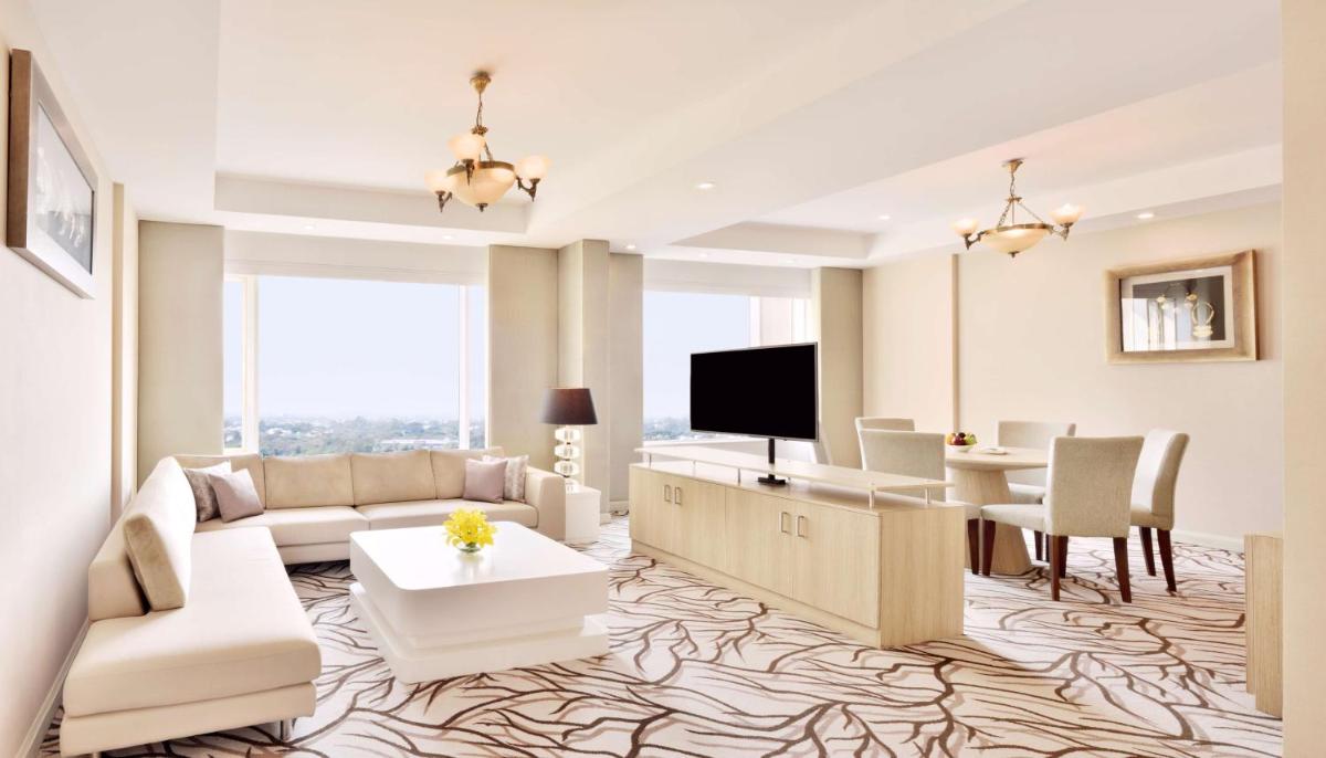 a living room with a couch and a table at Radisson Blu Bengaluru Outer Ring Road in Bengaluru