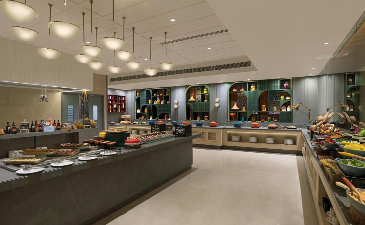 a bakery with many different types of food on display at Grand Mercure Agra - An Accor Brand in Agra