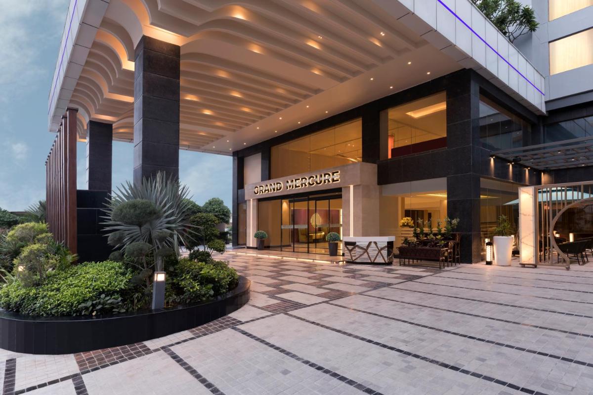 a lobby of a building with plants in front of it at Grand Mercure Agra - An Accor Brand in Agra