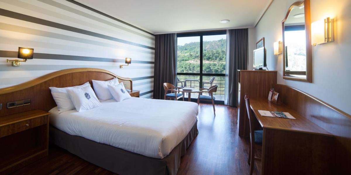 Cama o camas de una habitación en Laias Caldaria hotel y Balneario