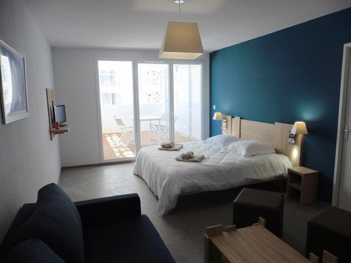 Un ou plusieurs lits dans un hébergement de l'établissement Appart'Hotel Odalys Nakâra