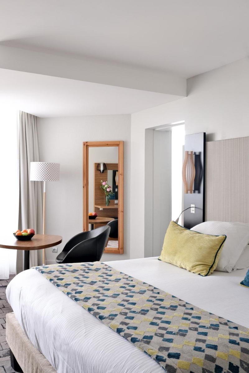 Un ou plusieurs lits dans un hébergement de l'établissement Thalazur Port-Camargue - Hotel & Spa