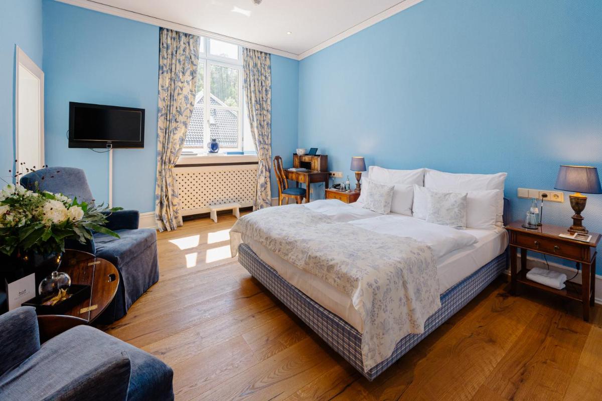 Ein Bett oder Betten in einem Zimmer der Unterkunft Schlosshotel Hugenpoet