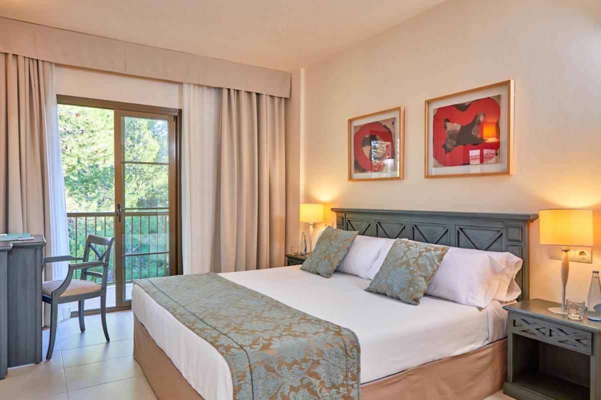 Cama o camas de una habitación en Zafiro Cala Mesquida