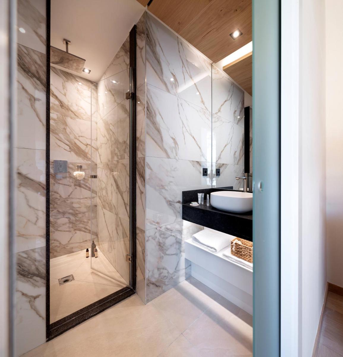 une salle de bain avec douche et lavabo dans l'établissement MGM Hôtels & Résidences - Hôtel Alhéna, à Flaine