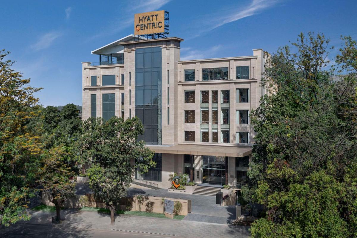a building with a sign on top of it at Hyatt Centric Rajpur Road Dehradun in Dehradun