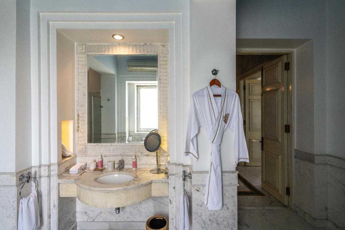 a bathroom with a white robe on a sink at Rajmahal Palace RAAS in Jaipur