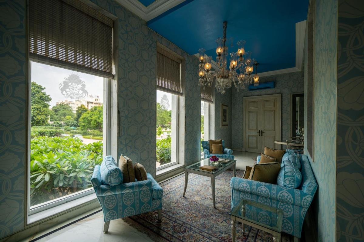 a living room with two chairs and a chandelier at Rajmahal Palace RAAS in Jaipur