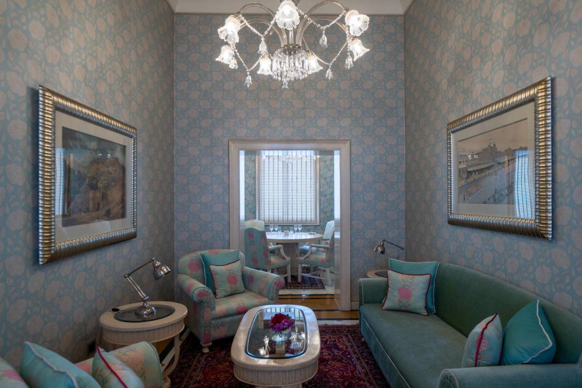 a living room with a couch and chairs and a chandelier at Rajmahal Palace RAAS in Jaipur
