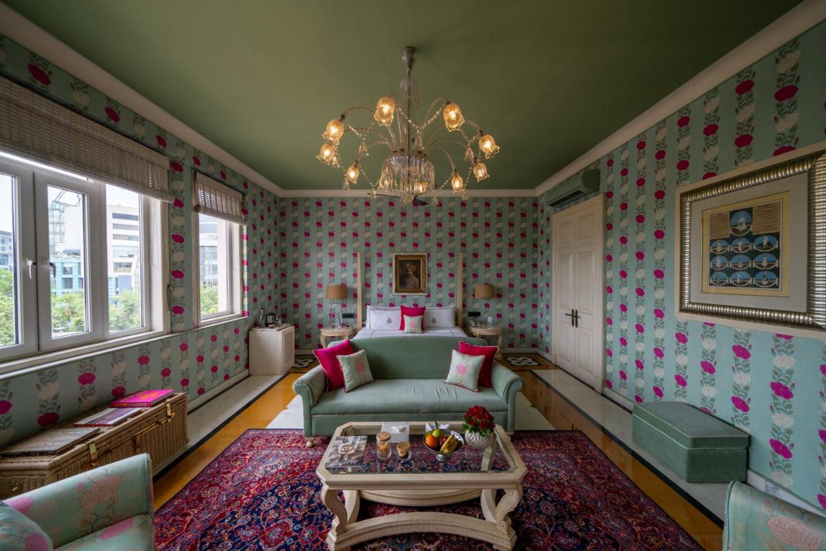 a living room with a couch and a chandelier at Rajmahal Palace RAAS in Jaipur
