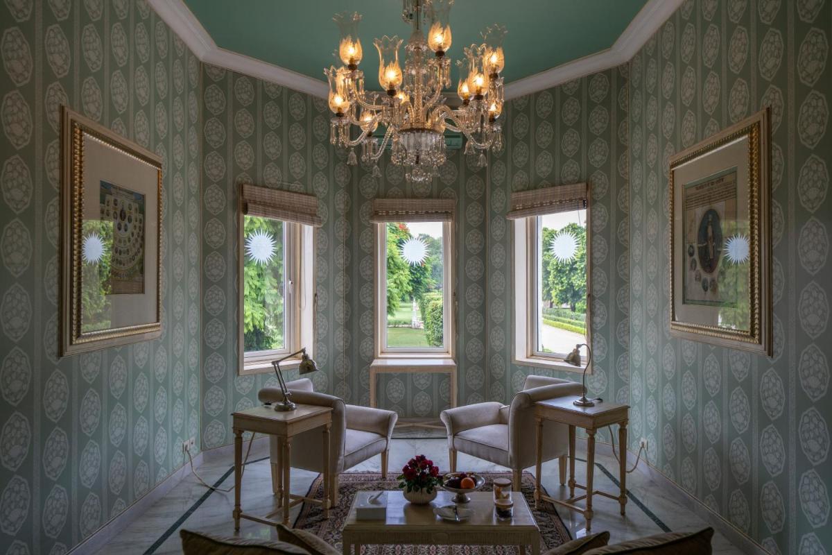 a drawing room with chairs and a chandelier at Rajmahal Palace RAAS in Jaipur