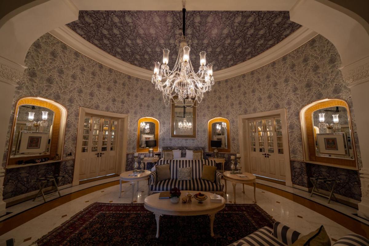 a living room with a chandelier and a couch at Rajmahal Palace RAAS in Jaipur