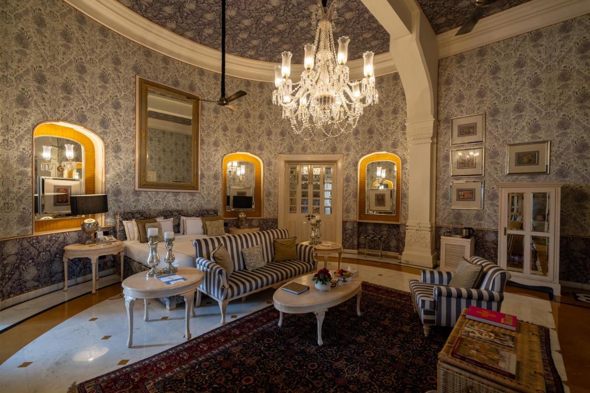 a living room with a couch and chairs and a chandelier at Rajmahal Palace RAAS in Jaipur