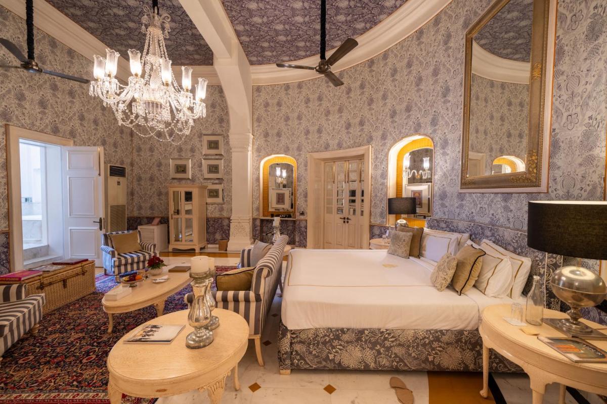 a bedroom with a bed and a living room at Rajmahal Palace RAAS in Jaipur