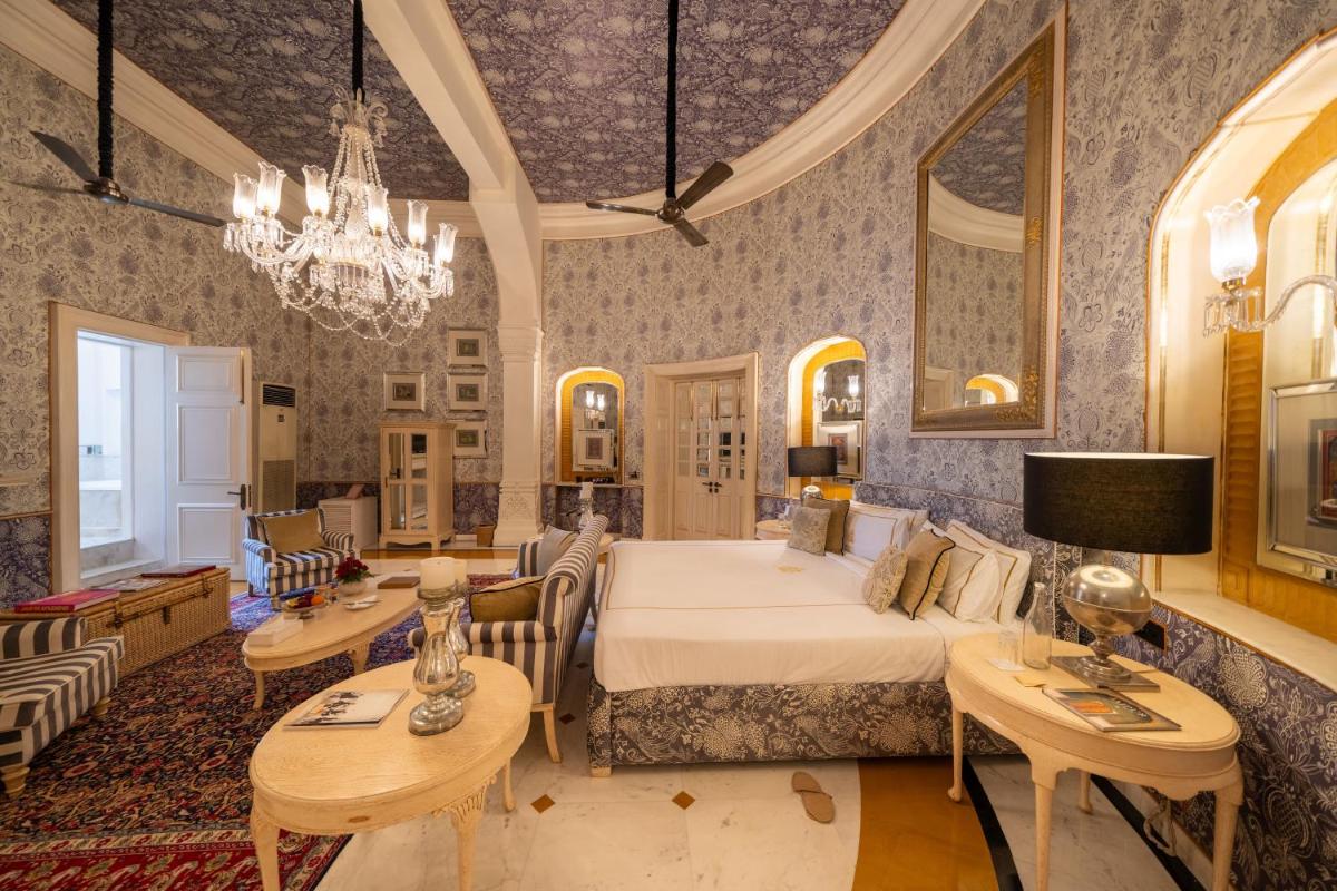 a bedroom with a bed and a living room at Rajmahal Palace RAAS in Jaipur