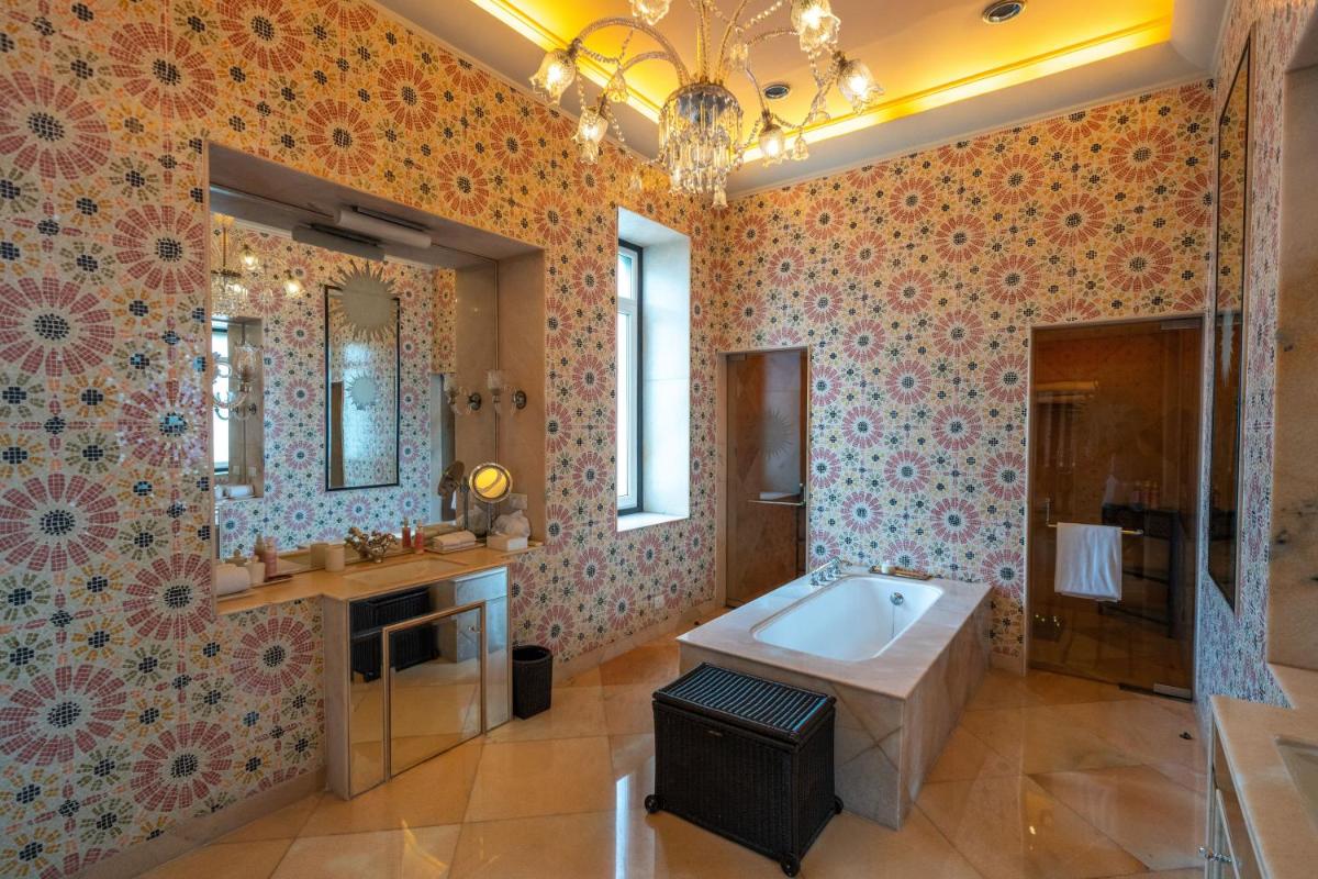 a bathroom with a tub and a sink at Rajmahal Palace RAAS in Jaipur