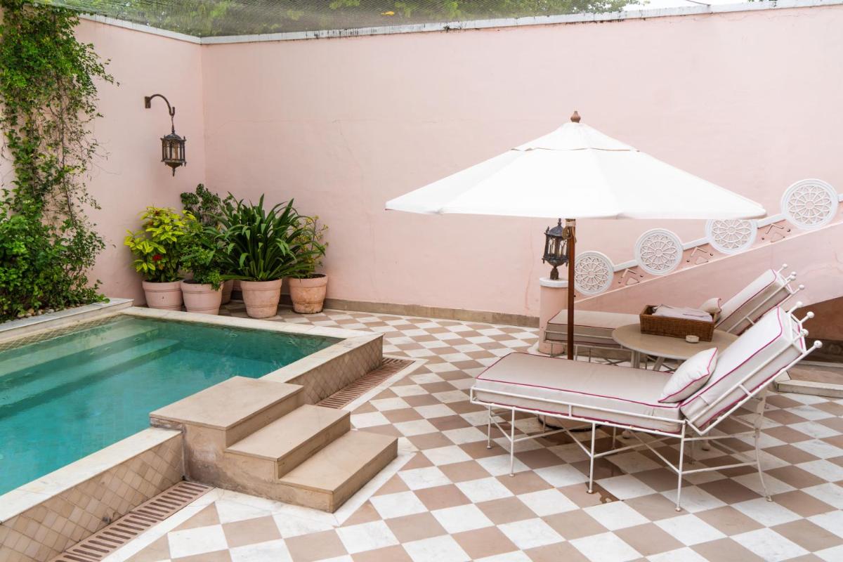 a patio with a pool and a table and chairs at Rajmahal Palace RAAS in Jaipur