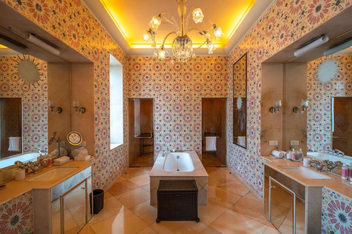 a large bathroom with two sinks and a large mirror at Rajmahal Palace RAAS in Jaipur