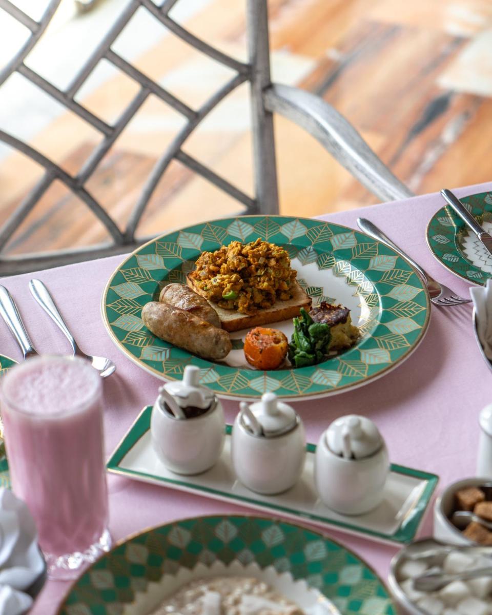 a table with a plate of food on a table at Rajmahal Palace RAAS in Jaipur