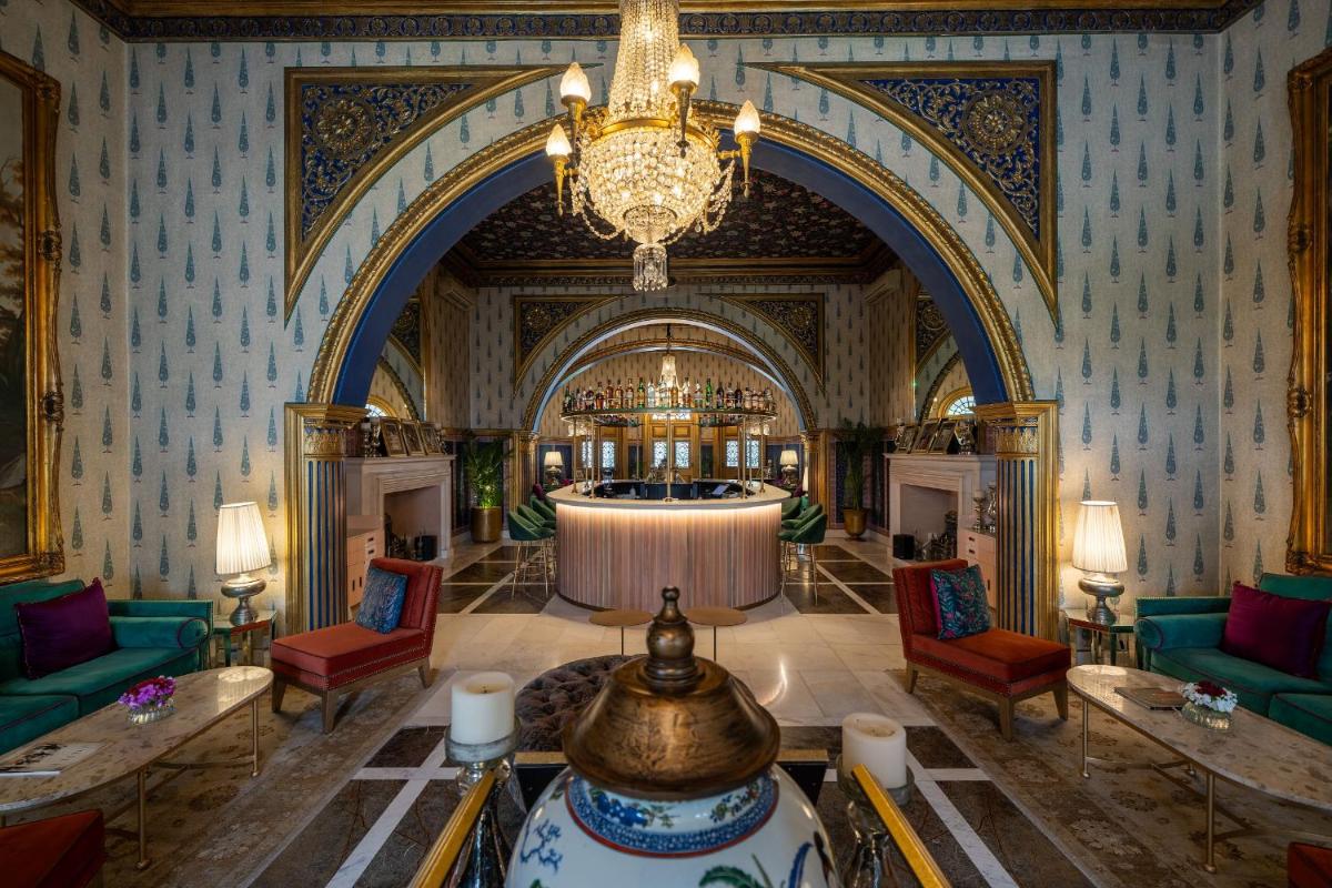 a large lobby with a chandelier and a table at Rajmahal Palace RAAS in Jaipur