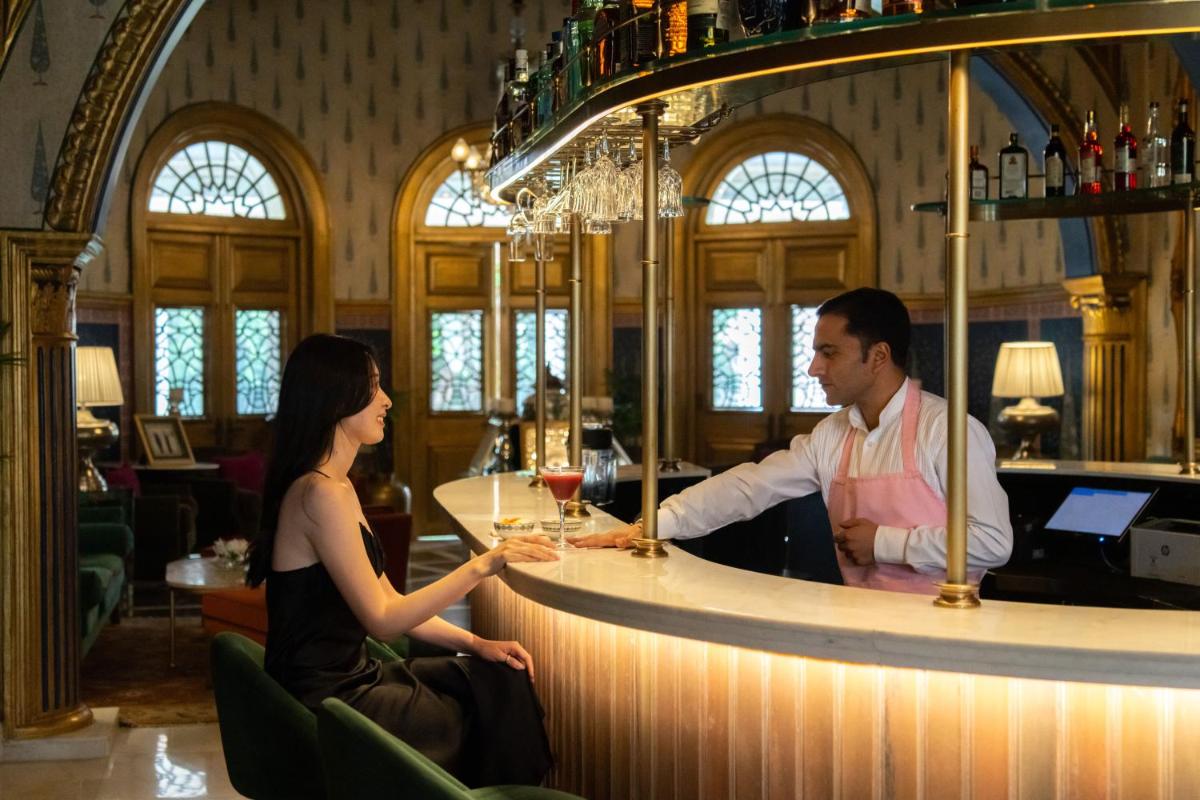a man and a woman sitting at a bar at Rajmahal Palace RAAS in Jaipur