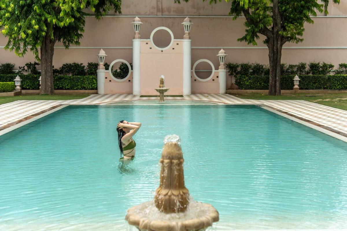 a person in the water in a swimming pool at Rajmahal Palace RAAS in Jaipur