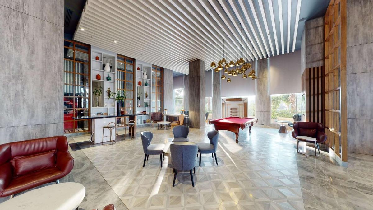 a lobby with chairs and a table in a room at Radisson RED Chandigarh Mohali in Chandīgarh