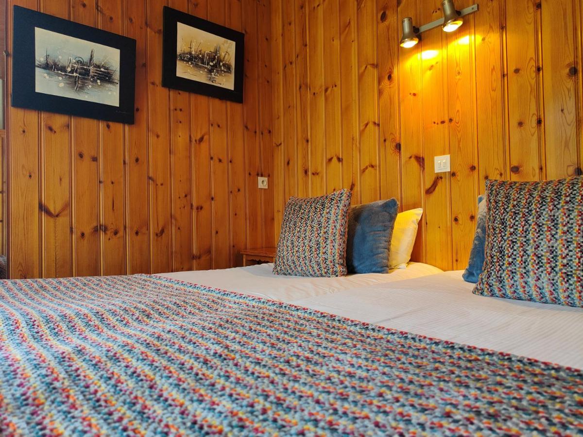 Un ou plusieurs lits dans un hébergement de l'établissement Aiguille du Midi - Hôtel & Restaurant