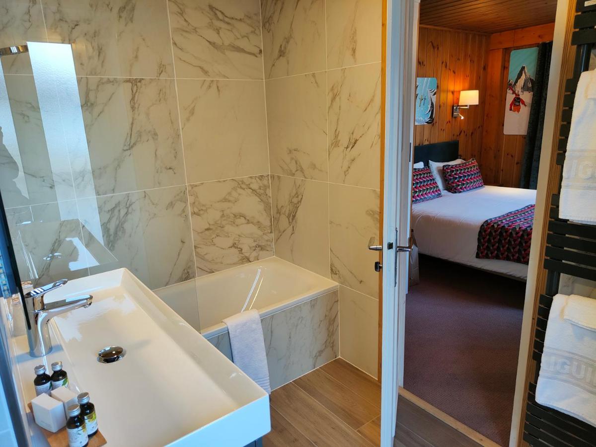 Un ou plusieurs lits dans un hébergement de l'établissement Aiguille du Midi - Hôtel & Restaurant