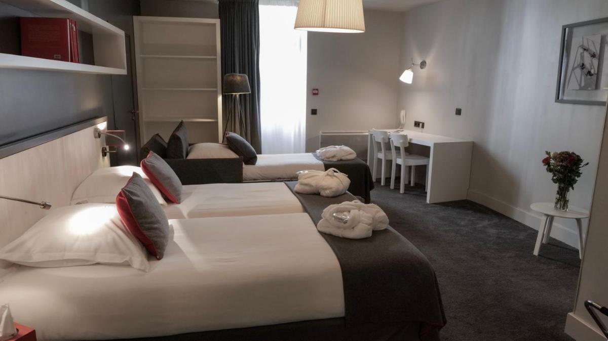 Un ou plusieurs lits dans un hébergement de l'établissement Le Faucigny - Hotel de Charme & SPA