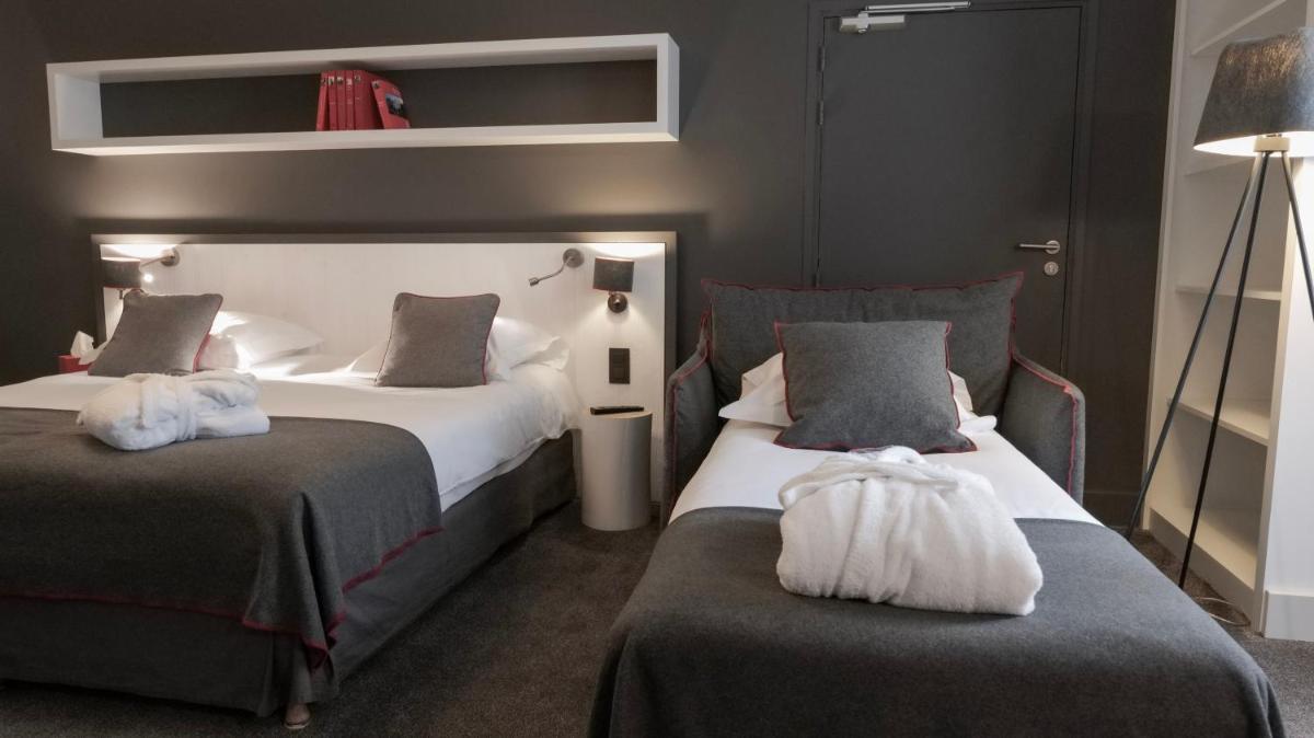Un ou plusieurs lits dans un hébergement de l'établissement Le Faucigny - Hotel de Charme & SPA