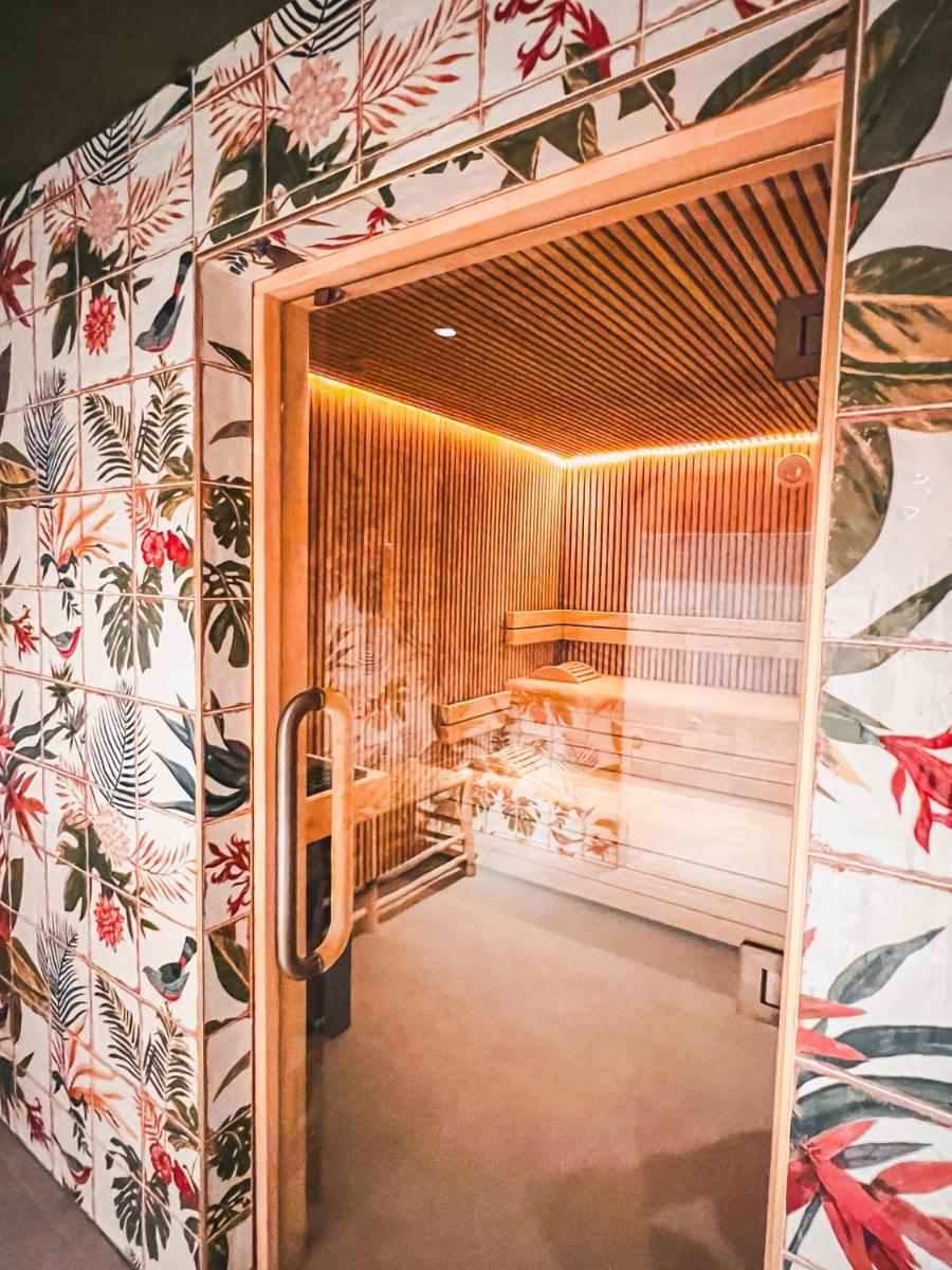 Un ou plusieurs lits dans un hébergement de l'établissement Bloom House Hôtel & SPA