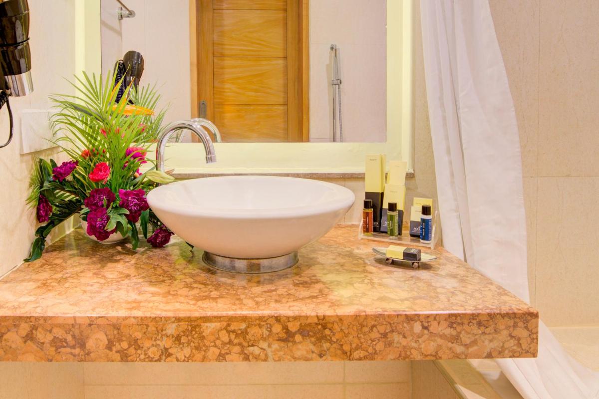 a bathroom counter with a sink and a mirror at Accord Puducherry in Puducherry