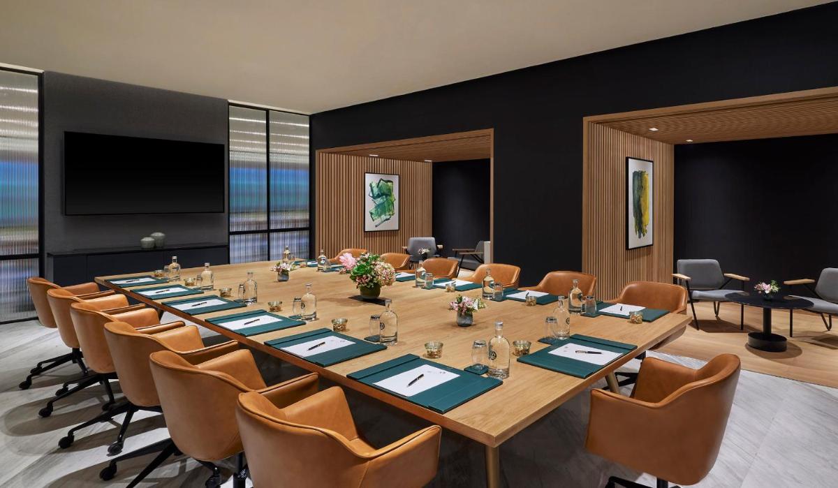 a large conference room with a long table and chairs at Taj The Trees, Mumbai in Mumbai