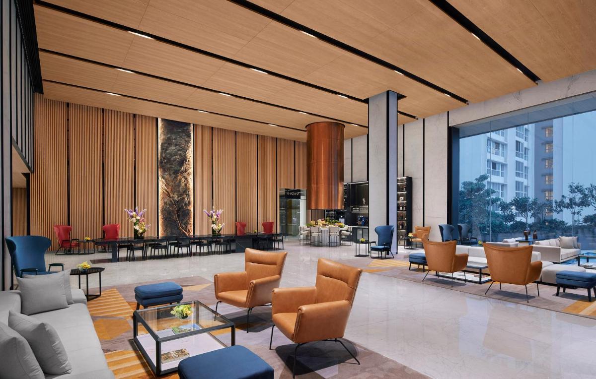 a lobby with couches and chairs in a building at Taj The Trees, Mumbai in Mumbai