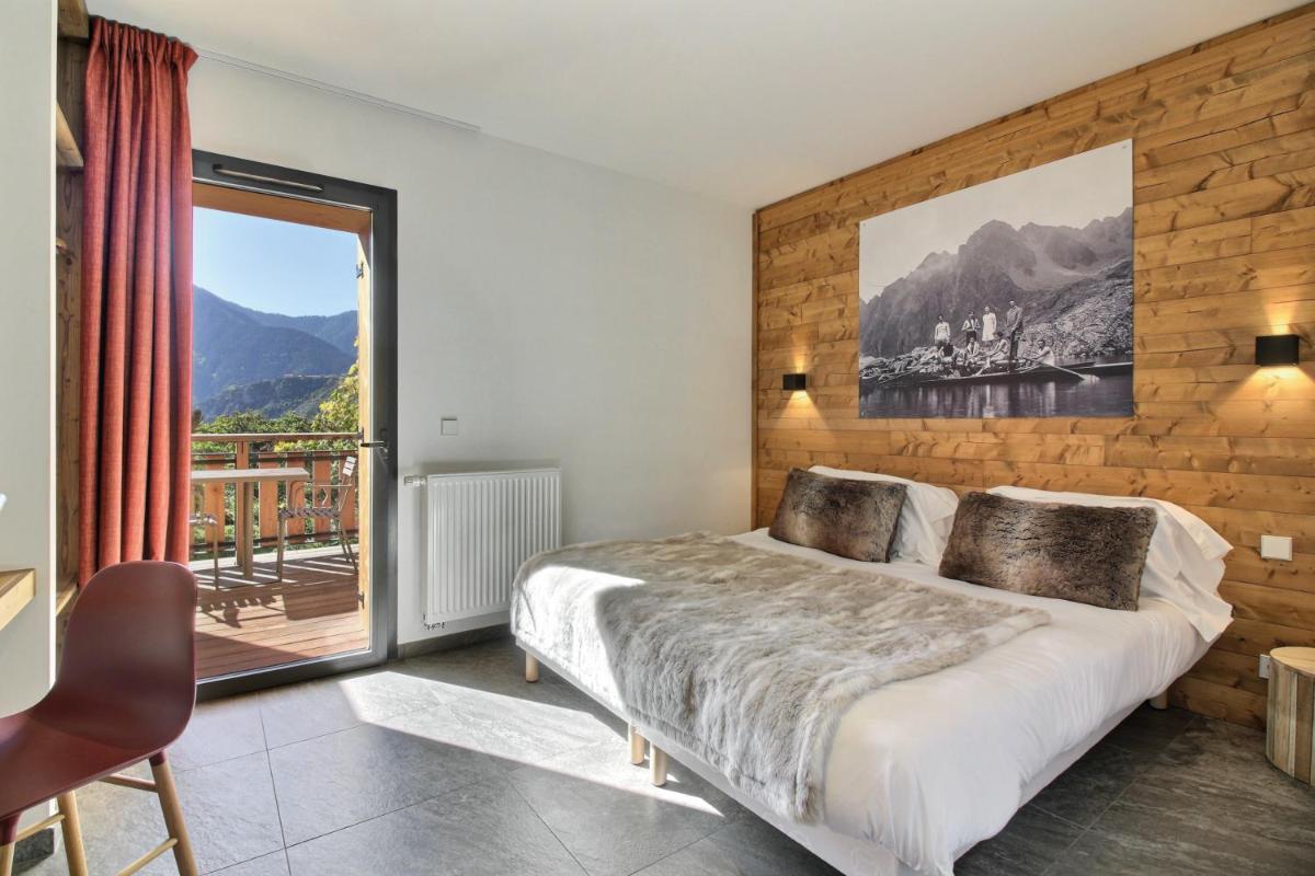 Un ou plusieurs lits dans un hébergement de l'établissement Pure Montagne Resort & Spa