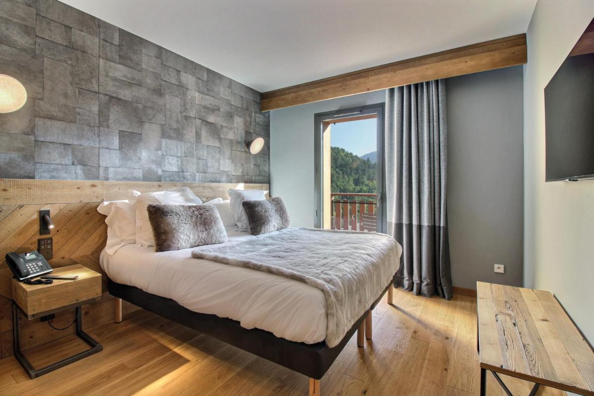 Un ou plusieurs lits dans un hébergement de l'établissement Pure Montagne Resort & Spa