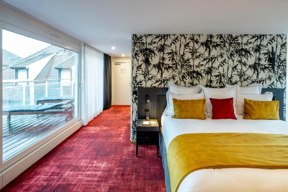 Un ou plusieurs lits dans un hébergement de l'établissement Hôtel Villa La Florangerie - SPA & Piscine