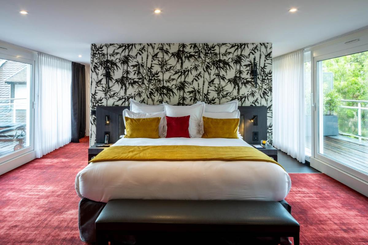 Un ou plusieurs lits dans un hébergement de l'établissement Hôtel Villa La Florangerie - SPA & Piscine